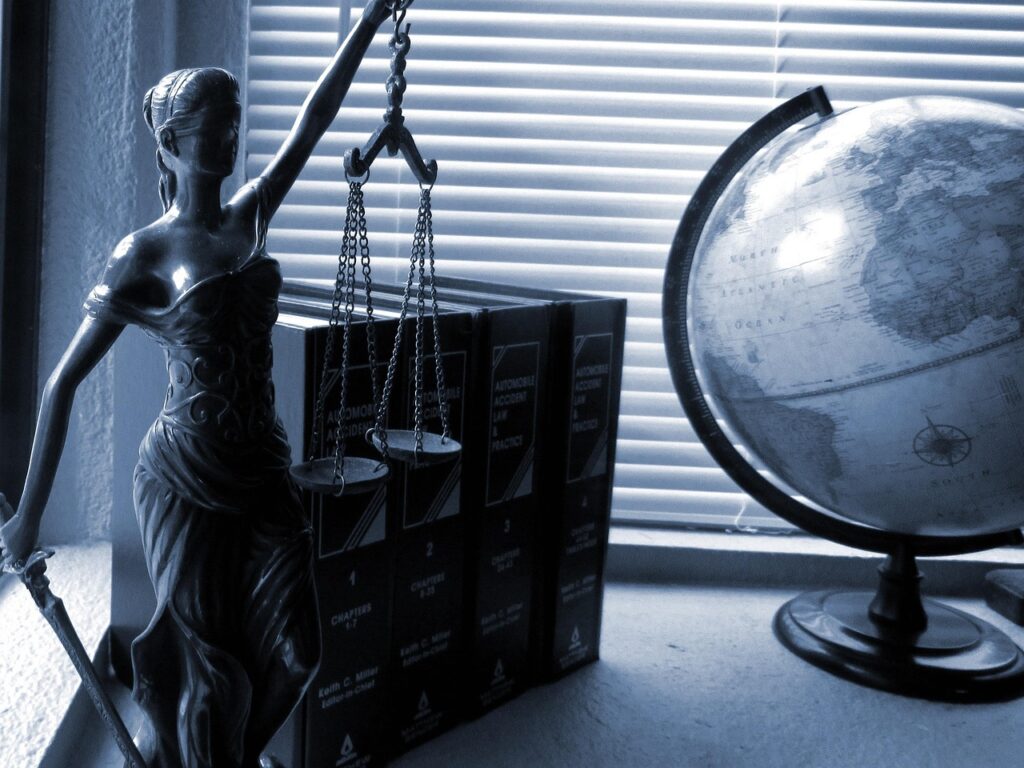 lady-justice-2388500_1280 Lady Justice, law books, and a globe on a desk